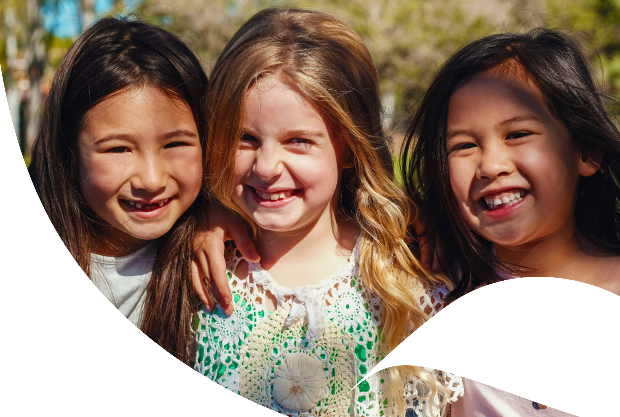 Three smiling girls around primary school age. From the cover of the Brain Building in Queensland Years in Review