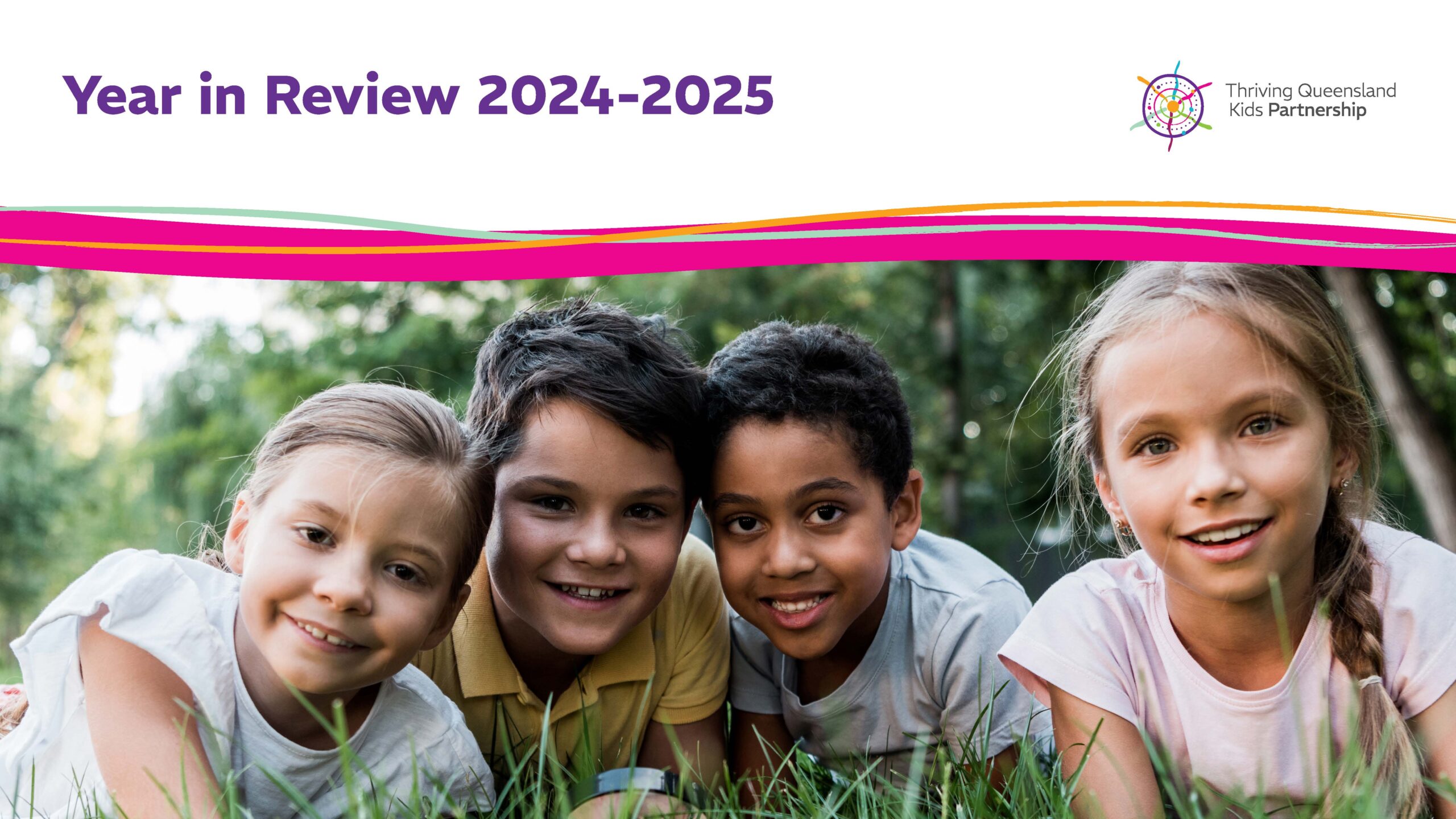 Four smiling children lying on grass, with "Year in Review 2024-2025" text and a colorful logo above them.