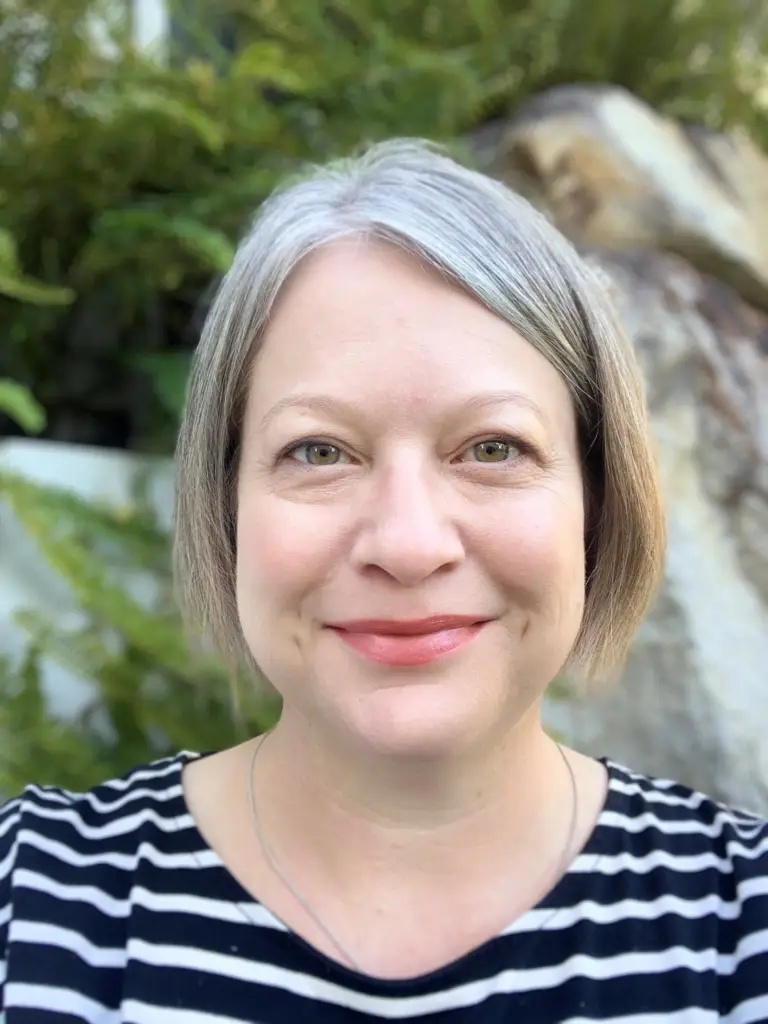 Headshot of Kym Dunstan wearing stripy top