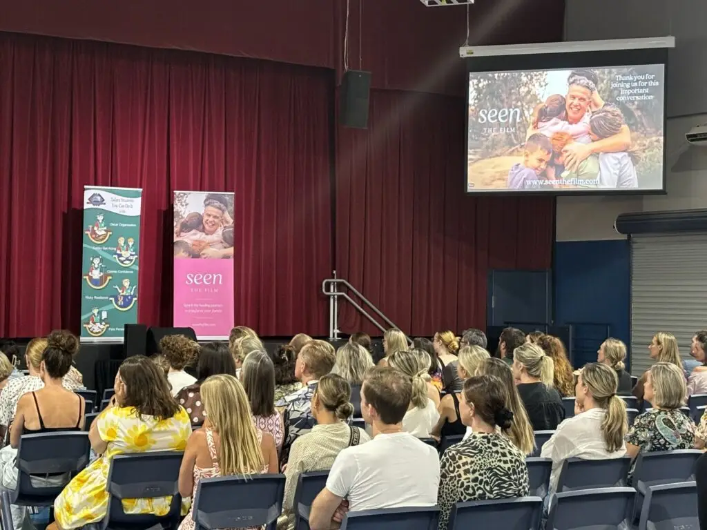 Large hall full of people watching a screening of Seen: The Film